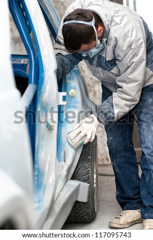 mechanic preparing the car for painting