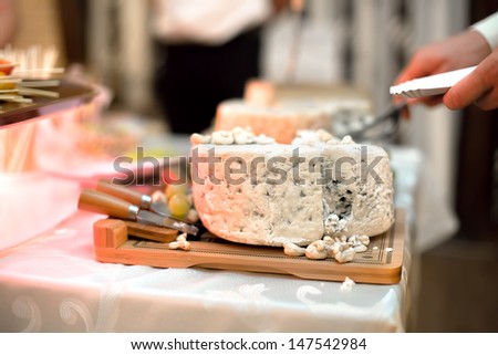 Various types of cheese as appetizers at dinner cocktail dress party