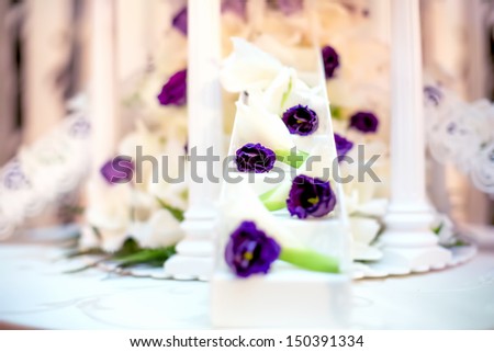 Wedding reception with close-up of white wedding cake decoration and flowers