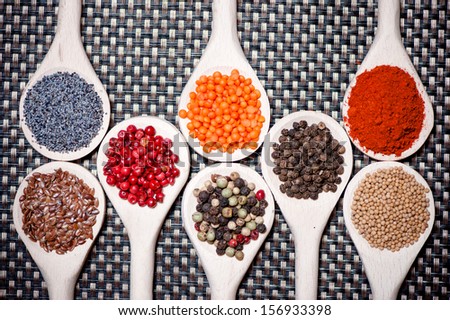 Collection of spices for healthy cooking. Mix of tarragon, bean seeds, poppy seeds, dry red hot chili, pepper and sesame