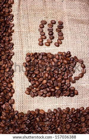 coffee beans mug on sack cloth background