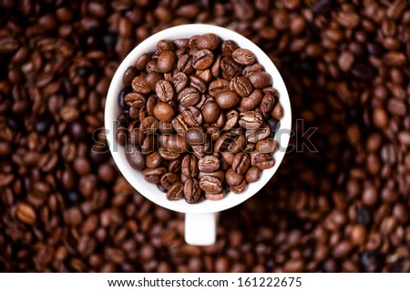 African fresh bio coffee beans with cup, detail view from top