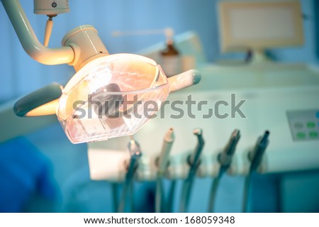 Close-up of dentist light on special chair and different tools in background