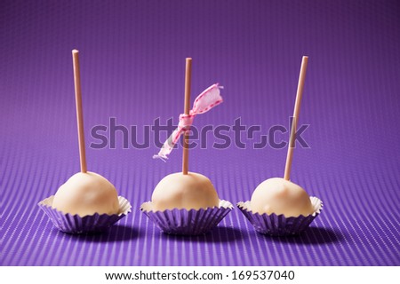 One bite homemade crunchy vanilla cupcakes with natural ingredients in pastry shop isolated on colorful background