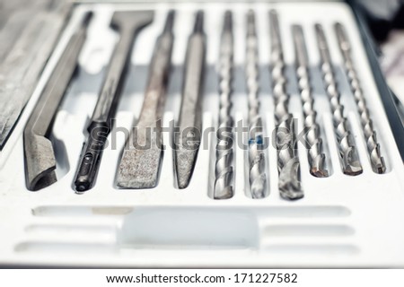 Plumber worker and mechanic tool set with drills and a flat chisel