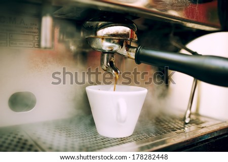 modern coffee and espresso machine pouring coffee