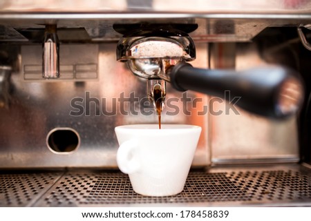 Espresso machine pouring coffee in pub, bar, restaurant
