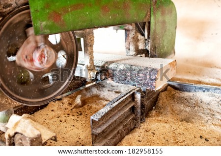 industrial wood production factory - close-up of industrial sawmill cutting a log