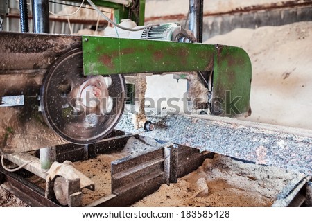 industrial wood production factory - close-up of band saw sawmill cutting wood