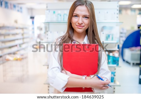 Female health care worker smiling in pharmacy