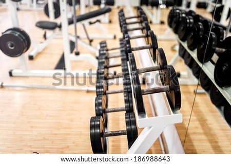 dumbbells in modern sports club, gym or fitness center. Weight Training Equipment