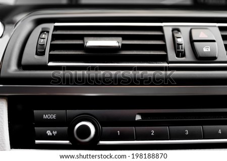 modern car interior with close-up of ventilation system holes and air conditioning. Concept wallpaper for auto air conditioning and climate control