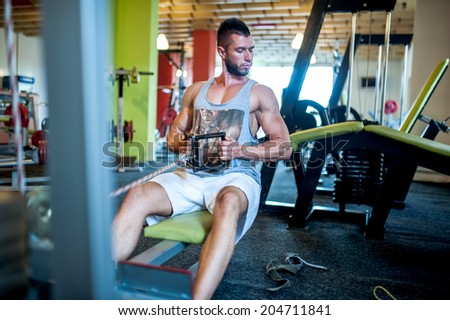 Athletic sexy adult model working out at gym, fitness and healthy lifestyle concept