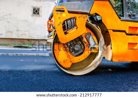 Heavy Tandem Vibration roller compactor at asphalt pavement works for road repairing.