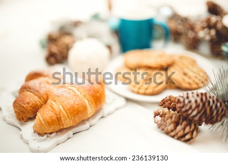 Breakfast in bed with croissants, biscuits, cookies and coffee. Soft effect.