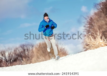 Athlete running on snow, preparing for hard training