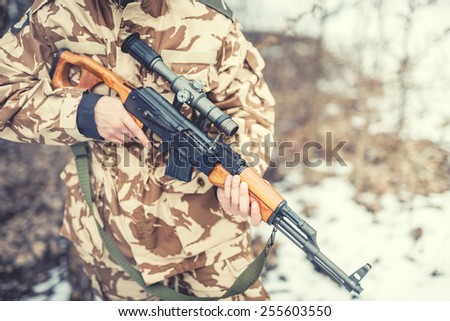 details of equipment and gun on military ranger - War, hunting or protection concept with man