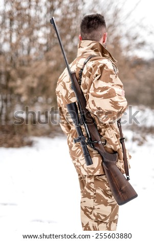 Portrait of military army man carrying a sniper rifle, for battlefield operations