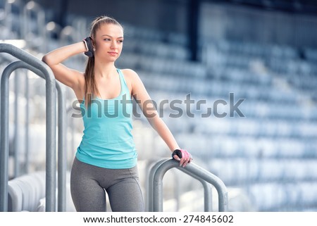 Young woman resting at training, preparing for marathon, jogging and running concept. Fitness trainer resting between sets on stairs