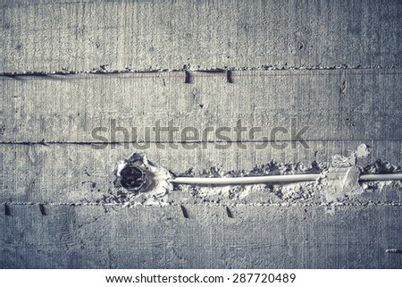 electrical wires and installation of cables in cement walls at construction site. soft effect on photo