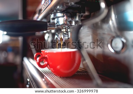 Automatic espresso machine pouring coffee in cups at restaurant or pub. Barista concept with machinery, tamper, coffee and tools