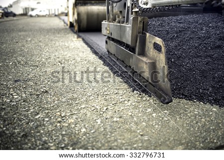 industrial pavement truck laying fresh asphalt, bitumen during road works. Construction of highways and road works
