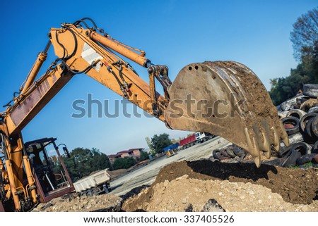 industrial bulldozer demolishing buildings and working on construction site