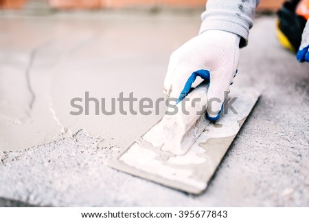 industrial worker on construction site laying sealant for waterproofing cement