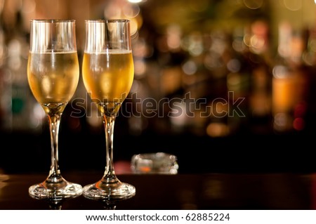 Two glasses of champagne waiting to be served by guests in a restaurant, new year\'s eve.