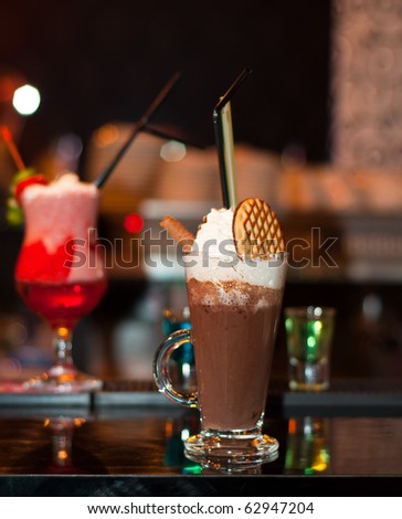 Cappuccino Frappe with fancy red cocktail on background