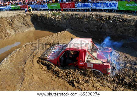 CLUJ NAPOCA, ROMANIA - SEPT. 26 : An Off-road car drives through water in a specially designed hole on Sept. 26, 2009 at 