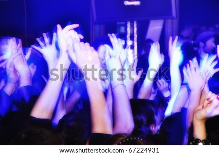 Cheering crowd at concert clapping and shouting