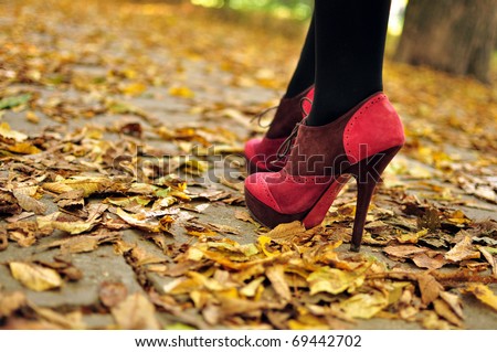 Woman feet  with pink fashion shoes on a late autumn shooting