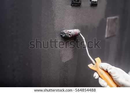 close up details of painting walls, industrial worker using small roller and tools for painting walls