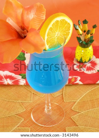 Blue tropical beverage in a hurricane glass