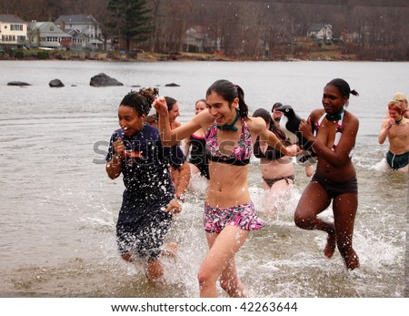 COVENTRY, CT - DECEMBER 5: A group of brave volunteers jump into icy lake waters to raise money for the Special Olympics at a \