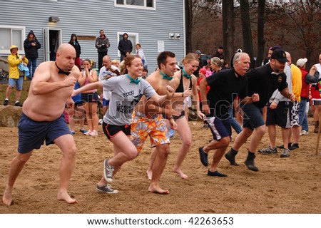 COVENTRY, CT - DECEMBER 5: Brave volunteers running toward a cold winter lake to raise money for the Special Olympics at a 