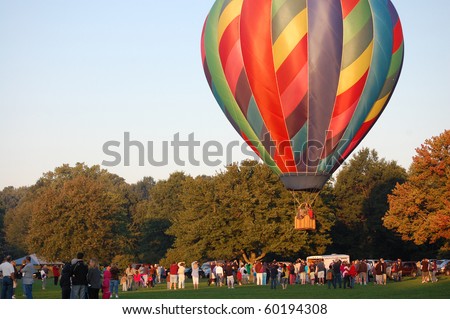 PLAINVILLE, CT - AUGUST 29: A crowd gathers to watch giant hot air balloons rise into the sky during the annual Plainville Hot Air Balloon Festival on August 29, 2010 in Plainville, Connecticut.
