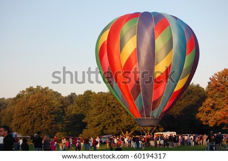 PLAINVILE, CT - AUGUST 29: A crowd gathers to watch giant hot air balloons rise into the sky during the annual Plainville Hot Air Balloon Festival on August 29, 2010 in Plainville, Connecticut.