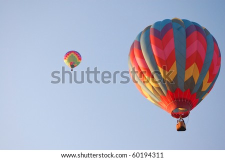 Two hot air balloons in the sky on a bright summer morning.
