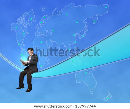 Businessman sitting and touch tablet with worldwide map background in blue sky