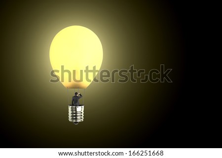Man taking glowing lamp balloon looking at distant place, in  dark background