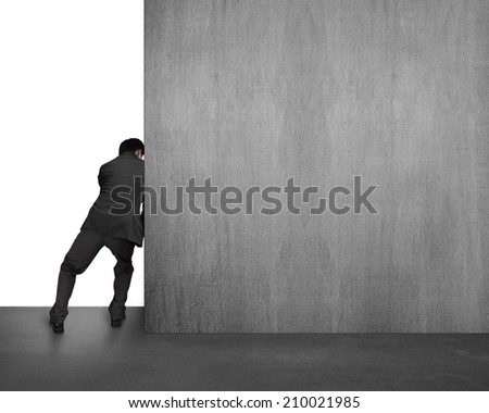 businessman pushing concrete wall away isolated on white background