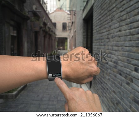 male hand wear smart watch with an index finger on street background