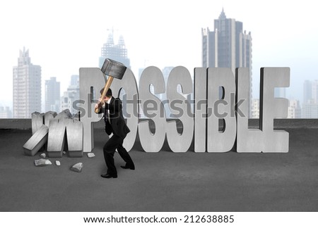 businessman hold sledgehammer to smash impossible 3D concrete word on cement floor and city skyscraper background