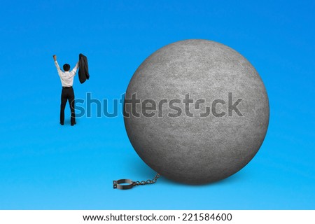 cheering man free from concrete ball shackle isolated on blue