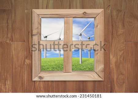 see wind power station through wooden window with teak textured wall background