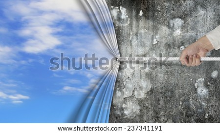 hand pulling natural sky curtain covered old dirty mottled concrete wall isolated on white background