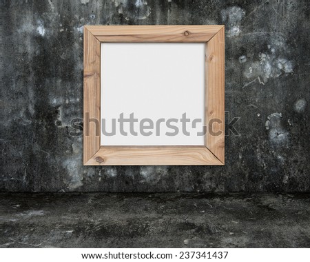 blank whiteboard with wooden frame on dark mottled concrete wall and floor background