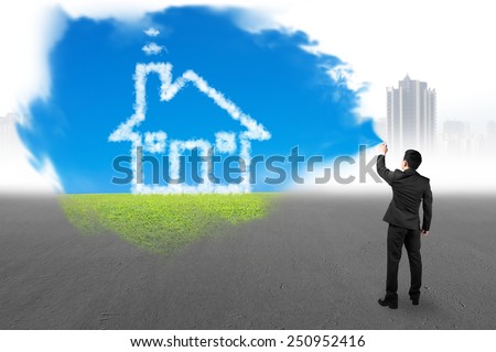 Businessman spraying house cloud sky grass paint covered gray cityscape background